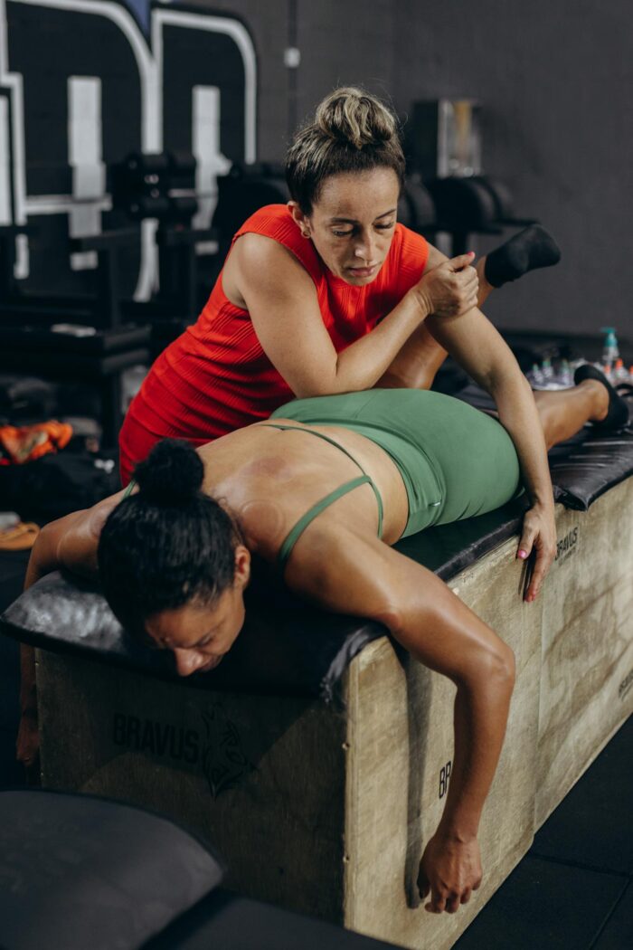 A woman doing a leg exercise with a trainer